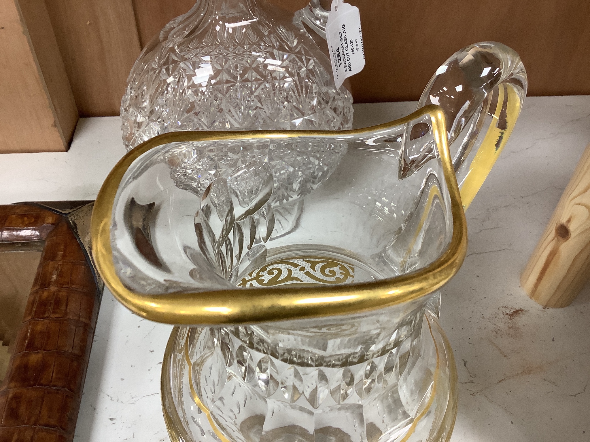 A Baccarat gilt and cut glass jug and a strawberry cut glass decanter and stopper, tallest 38 cm